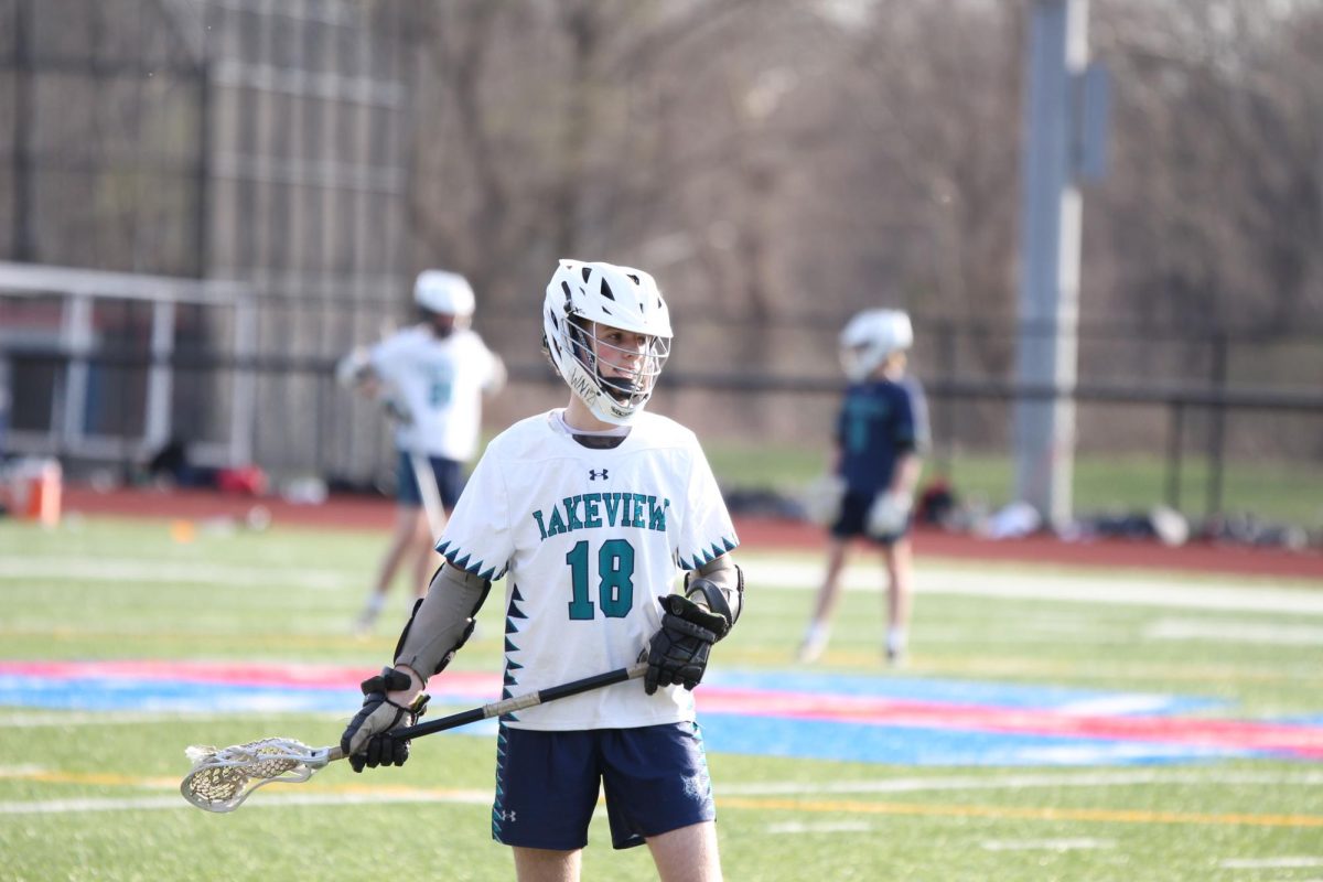 Former Lacrosse co-op player, Cameron Packett number 18, warms up for his game. Other co-op players, like Musso, have noticed the deep connection between Lakeview and Nonnewaug.