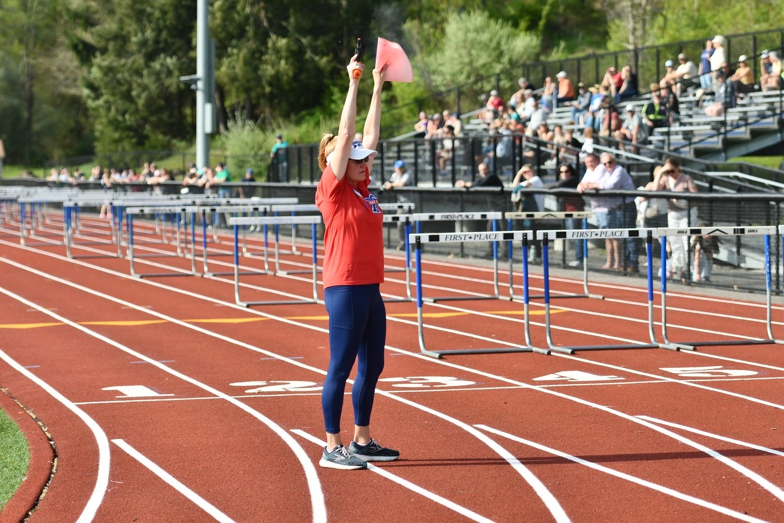 Deb Flaherty prepares to start a heat of the boys 110 meter hurdles during the track and field home meet vs. Lakeview and Shepaug high schools on May 4, 2026. Flaherty dedicates much of her time and energy to the team, and her background of being a cross country runner and in social work has contributed to her being the epitome of a devoted, nurturing coach.