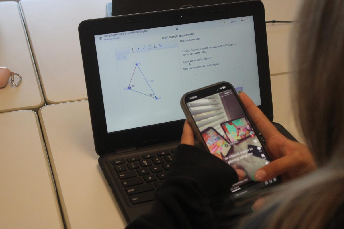 NHS student, continuously scrolls on their phone during a study hall, disregarding their math homework and being unsuccessful in prioritizing academics. This time of year is normally very popular for losing students' motivation. 