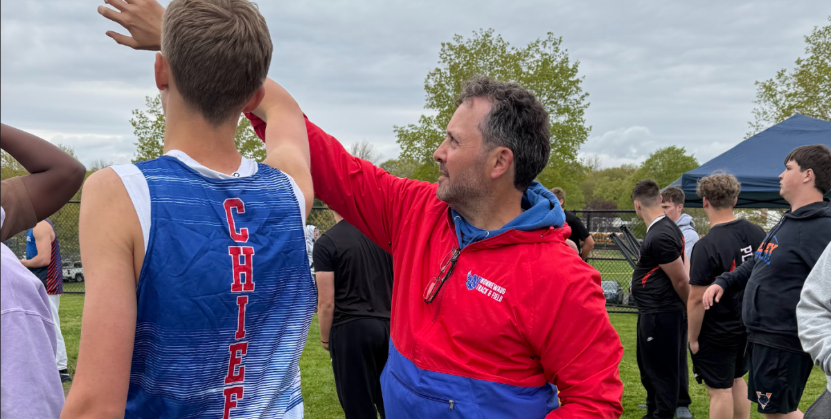 NHS track coach Joe Flaherty gives team member Austin Dietrich pointers ahead of a spring meet. Flaherty's work with the team has this year's group poised for success ahead of tomorrow's Berkshire League Championship. (Photo Credit - Contributed) 