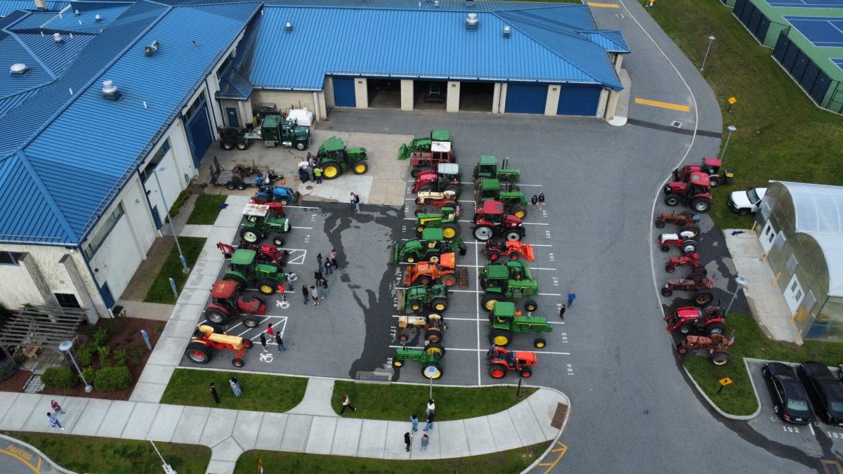 33 tractors pile into the NHS parking lot, right as the sun comes up on tractor day 2025.  This event has grown with such popularity that it merited FOX 61 News to arrive and cover last year’s Drive Your Tractor to School Day.  (Photo Credit - Andrew Zielisnki)