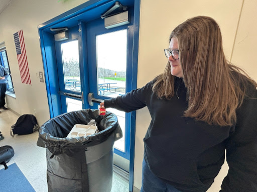 Emily Lazurek throws out her trash after finishing her lunch.