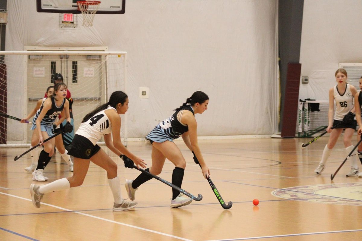 Anna Crocker races towards the ball at the AIM indoor field hockey tournament in The NYA Sports and Fitness center. Crocker, like many others, competes on a club team.  (Courtesy of Anna Crocker.)