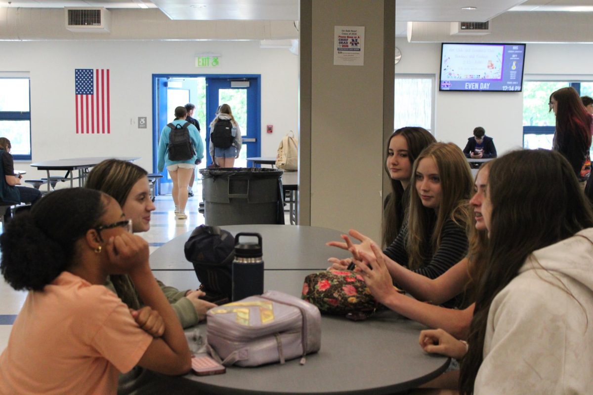 Students at Nonnewaug High school socialize during lunch. Moments like these are important because it decreases stress and students  get to put aside their busy workload for just a bit and catch up with their classmates. 