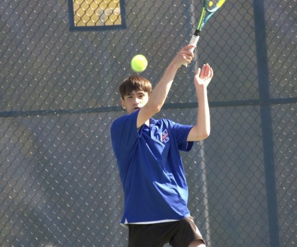 Senior captain Luke Primini hits a shot on May 3rd against Housatonic. Primini is a senior captain of the boys team and has played a key role in boys success this year. (courtesy of Roger Nelson)
