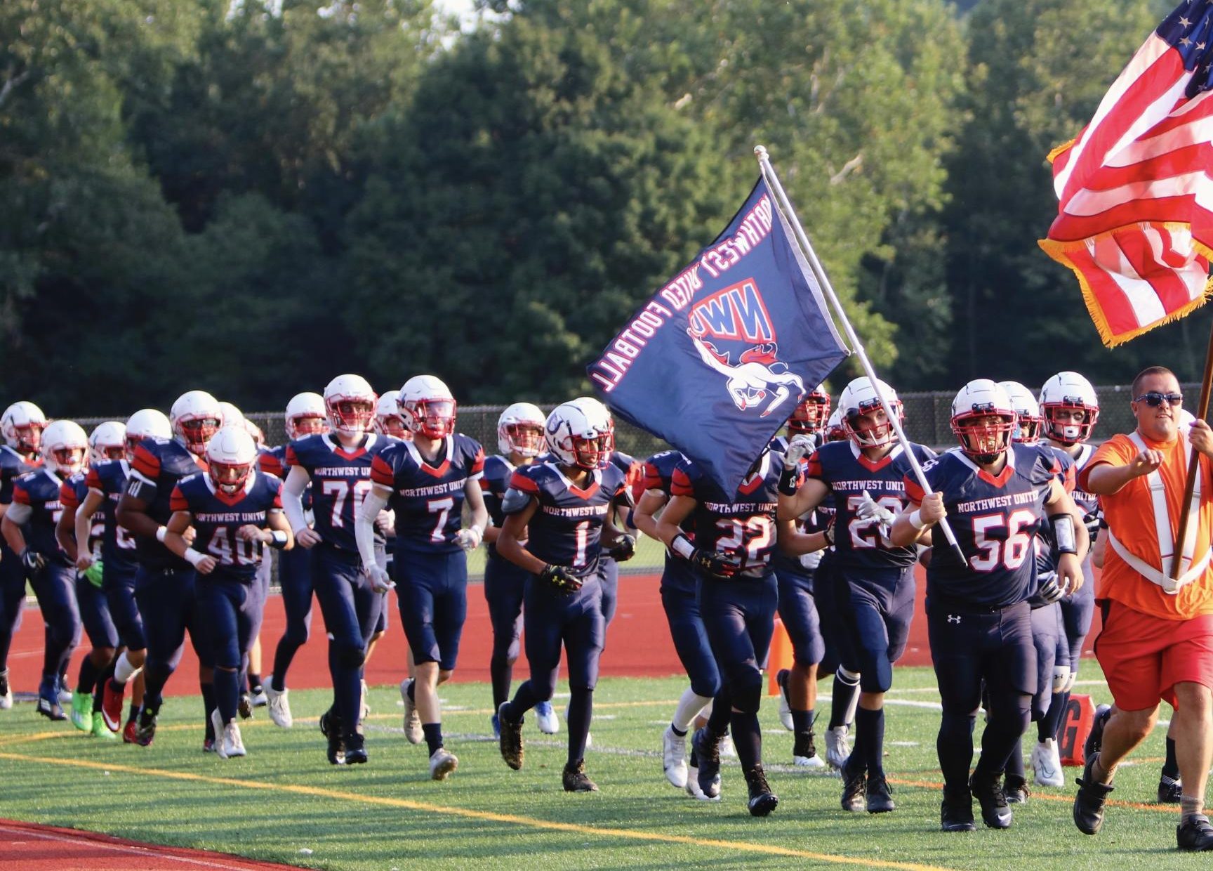The Northwest United Football team makes their grand entrance to a game in 2022. The co-op which consisted of Wolcott Tech, Nonnewaug, Shepaug Valley, Litchfield, and Wamogo was one of the many ways in which Berkshire League teams connect. (Photo Credit: Noreen Chung)